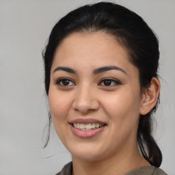 Joyful latino young-adult female with medium  brown hair and brown eyes