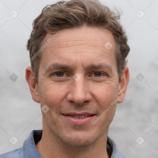 Joyful white adult male with short  brown hair and grey eyes