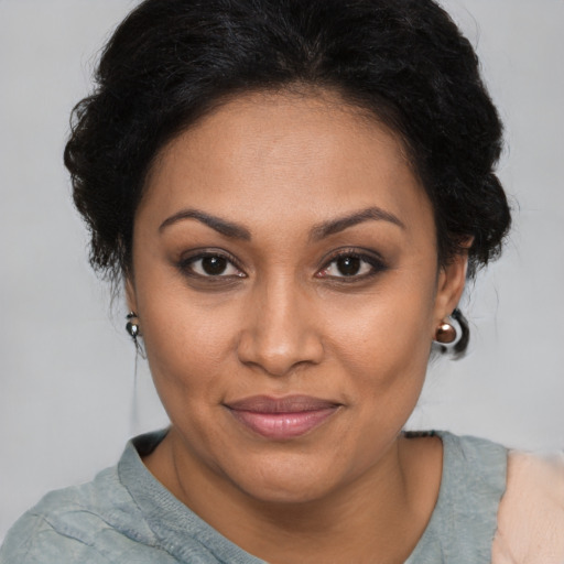 Joyful black adult female with medium  brown hair and brown eyes