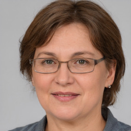 Joyful white adult female with medium  brown hair and blue eyes