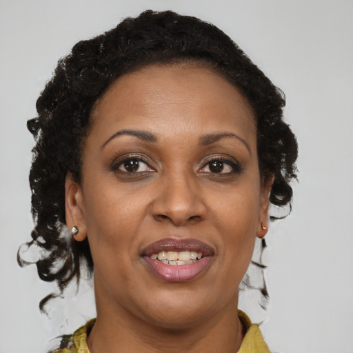 Joyful black adult female with medium  brown hair and brown eyes