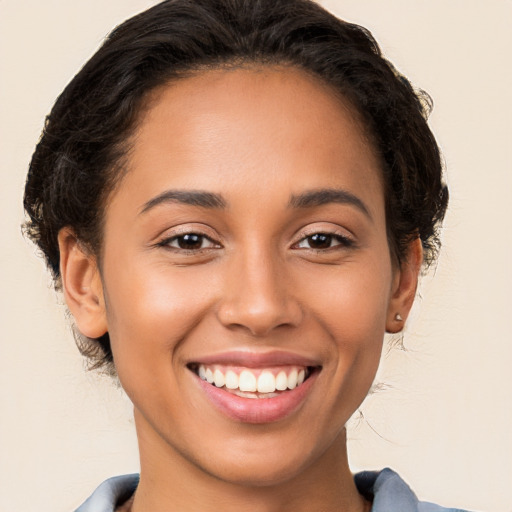 Joyful latino young-adult female with long  brown hair and brown eyes