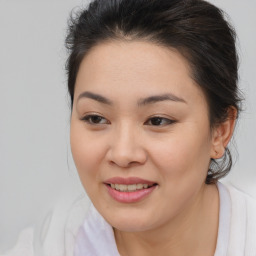 Joyful asian young-adult female with medium  brown hair and brown eyes