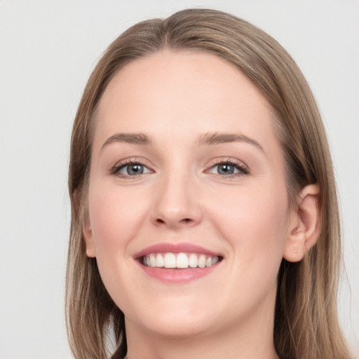 Joyful white young-adult female with long  brown hair and blue eyes