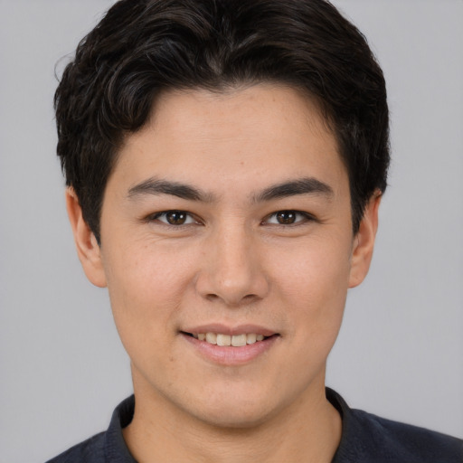 Joyful asian young-adult male with short  brown hair and brown eyes