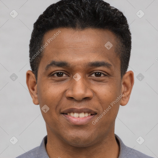 Joyful black young-adult male with short  black hair and brown eyes