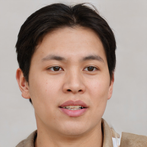 Joyful asian young-adult male with short  brown hair and brown eyes