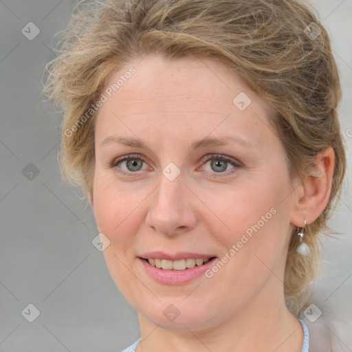 Joyful white adult female with medium  brown hair and blue eyes