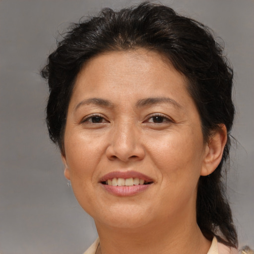 Joyful asian adult female with medium  brown hair and brown eyes