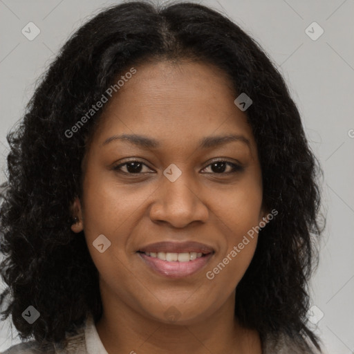 Joyful black young-adult female with long  brown hair and brown eyes