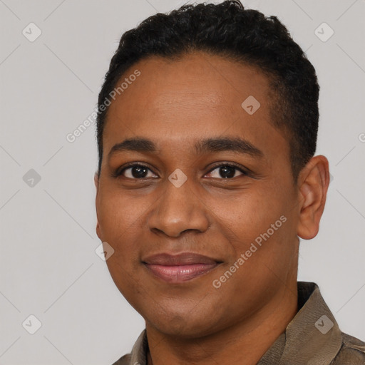 Joyful black young-adult male with short  black hair and brown eyes