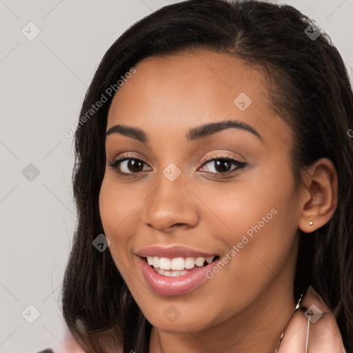 Joyful latino young-adult female with long  brown hair and brown eyes