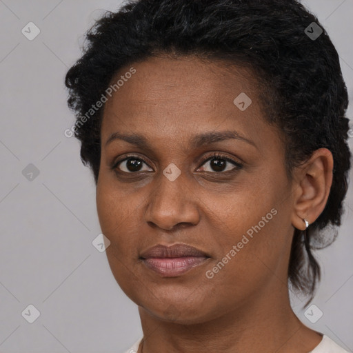 Joyful black adult female with short  brown hair and brown eyes