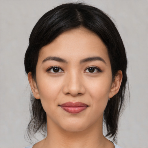 Joyful latino young-adult female with medium  black hair and brown eyes
