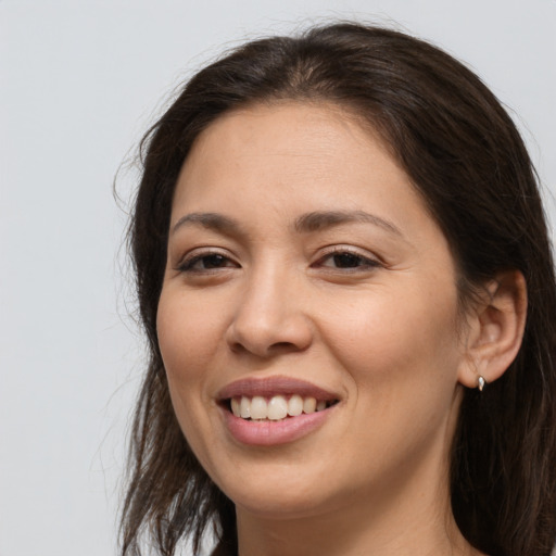 Joyful white young-adult female with long  brown hair and brown eyes