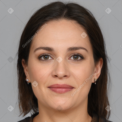 Joyful white adult female with medium  brown hair and brown eyes