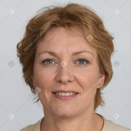 Joyful white adult female with medium  brown hair and blue eyes