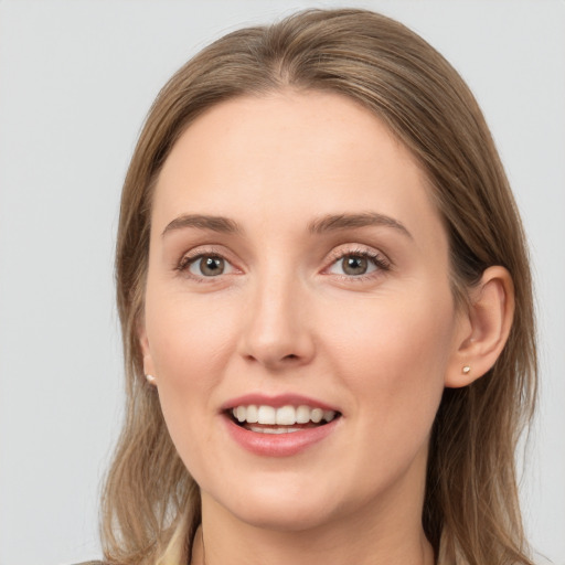 Joyful white young-adult female with long  brown hair and grey eyes