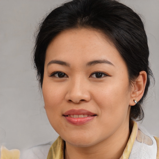 Joyful asian young-adult female with medium  brown hair and brown eyes