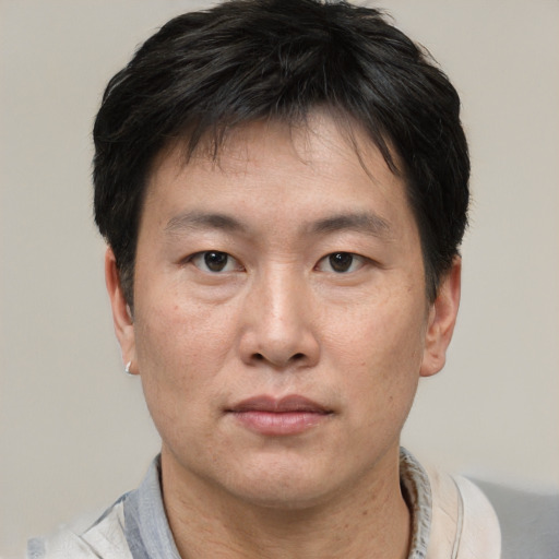 Neutral asian adult male with short  brown hair and brown eyes
