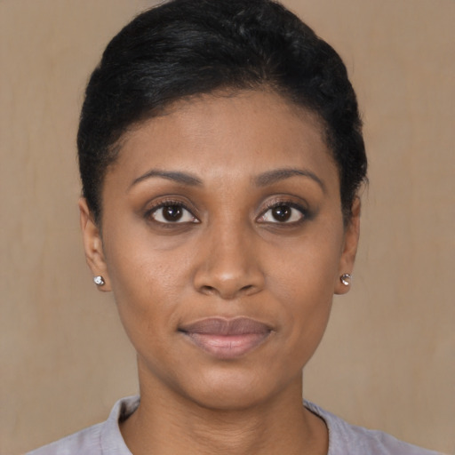 Joyful black young-adult female with short  black hair and brown eyes