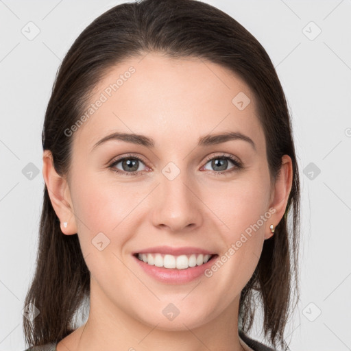 Joyful white young-adult female with long  brown hair and grey eyes