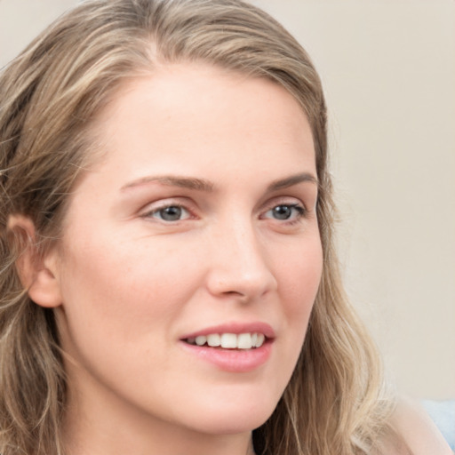 Joyful white young-adult female with long  brown hair and blue eyes