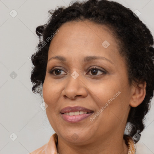 Joyful black adult female with medium  brown hair and brown eyes