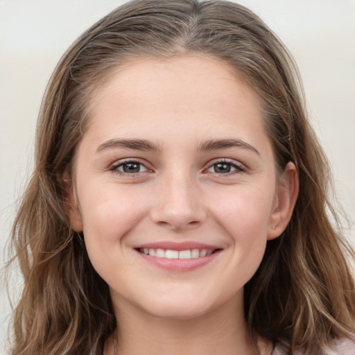 Joyful white young-adult female with long  brown hair and grey eyes