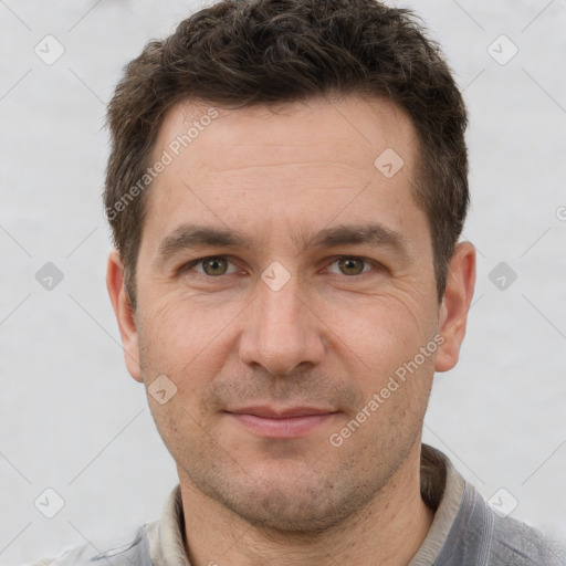 Joyful white adult male with short  brown hair and grey eyes