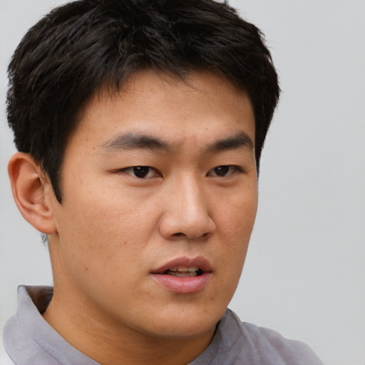 Neutral asian young-adult male with short  brown hair and brown eyes