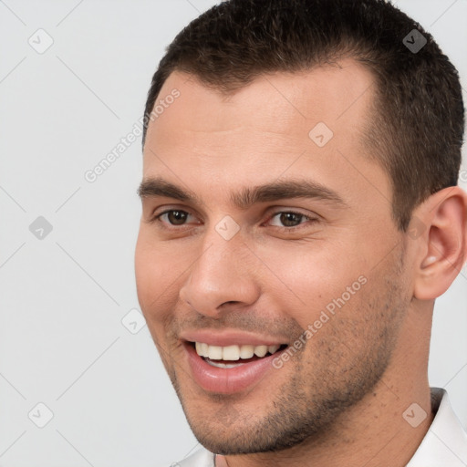 Joyful white young-adult male with short  brown hair and brown eyes