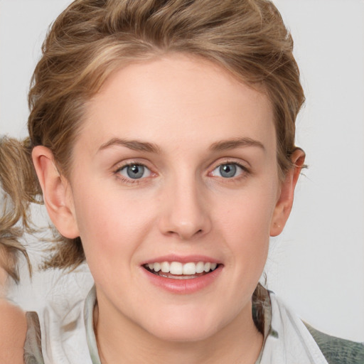 Joyful white young-adult female with medium  brown hair and blue eyes