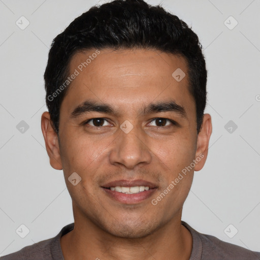 Joyful white young-adult male with short  black hair and brown eyes