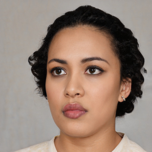 Neutral latino young-adult female with medium  black hair and brown eyes