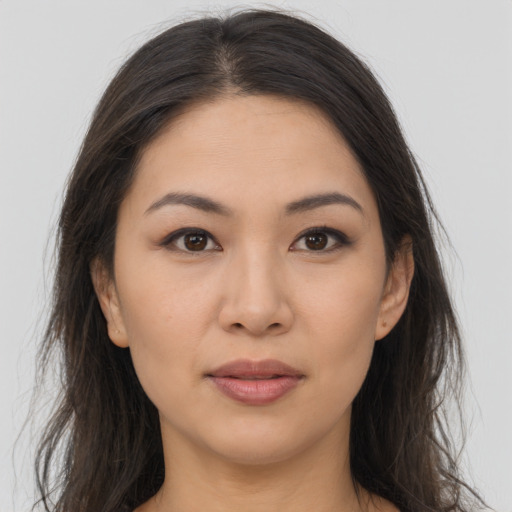 Joyful asian young-adult female with long  brown hair and brown eyes