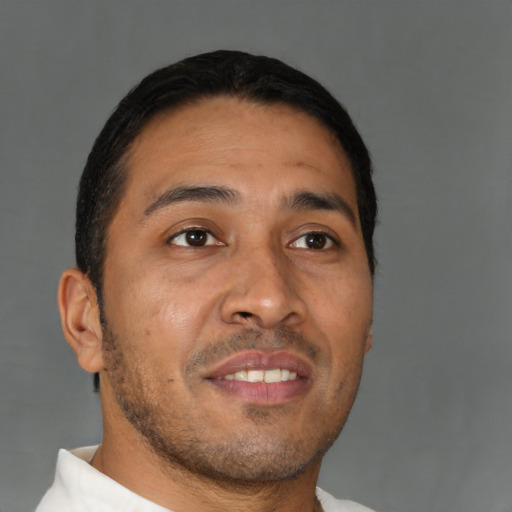 Joyful asian young-adult male with short  brown hair and brown eyes