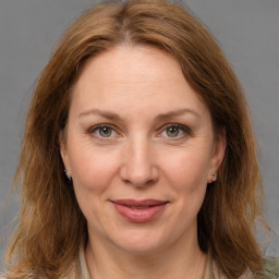 Joyful white adult female with medium  brown hair and grey eyes