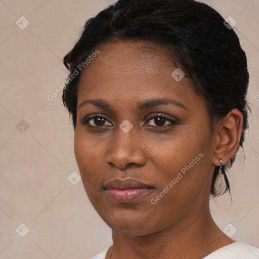 Joyful black young-adult female with short  brown hair and brown eyes