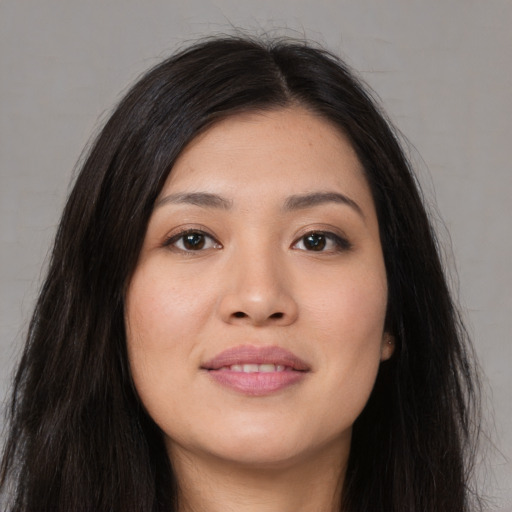 Joyful white young-adult female with long  black hair and brown eyes