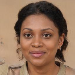 Joyful black adult female with medium  brown hair and brown eyes