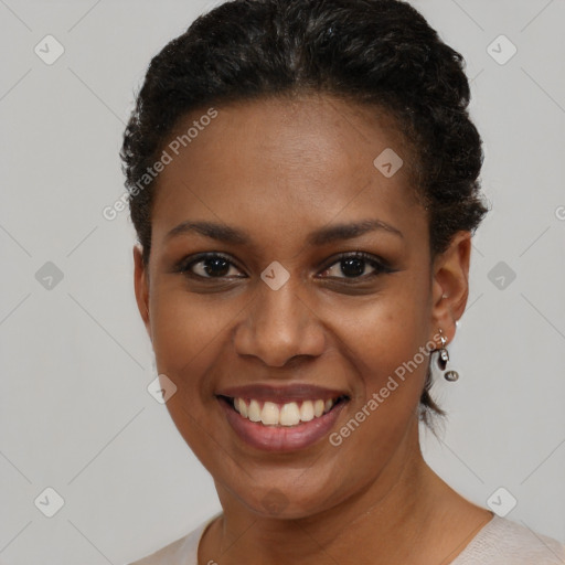 Joyful black young-adult female with short  brown hair and brown eyes