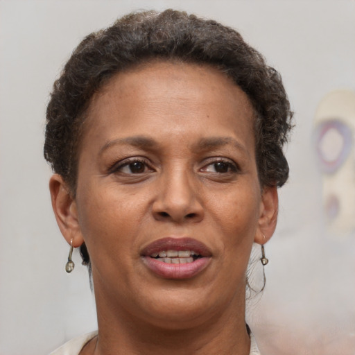 Joyful black adult female with short  brown hair and brown eyes