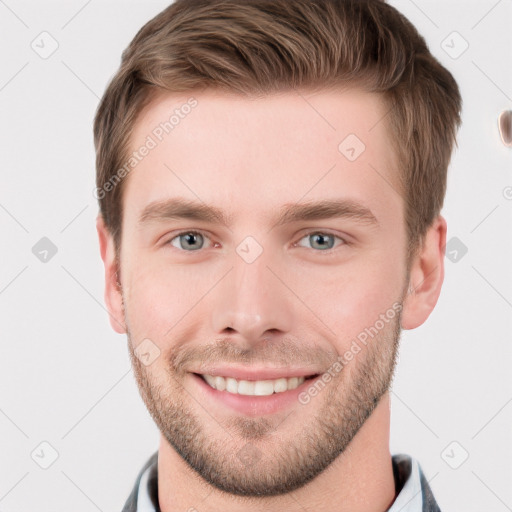 Joyful white young-adult male with short  brown hair and grey eyes