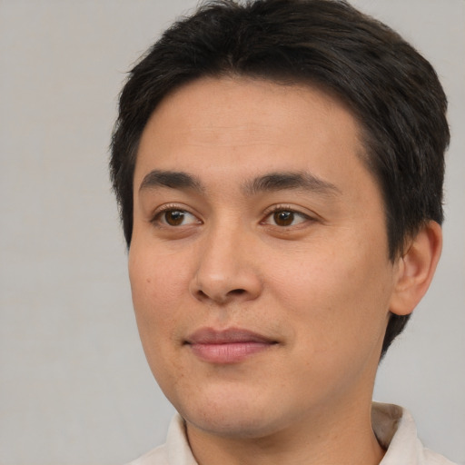 Joyful asian young-adult male with short  brown hair and brown eyes