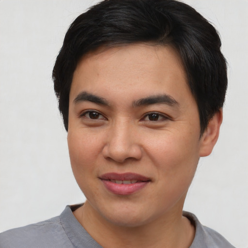 Joyful asian young-adult male with short  brown hair and brown eyes