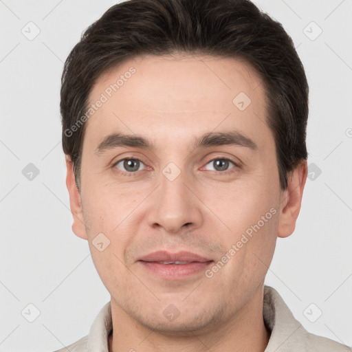 Joyful white adult male with short  brown hair and brown eyes