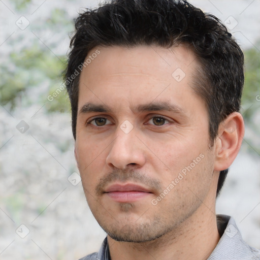 Joyful white young-adult male with short  black hair and brown eyes