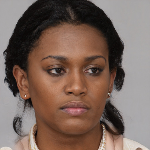 Neutral black young-adult female with medium  brown hair and brown eyes
