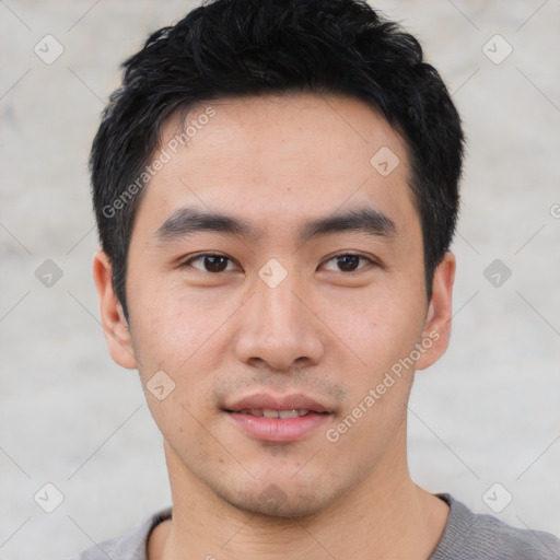 Joyful asian young-adult male with short  black hair and brown eyes